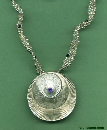 Engraved silver pendant
